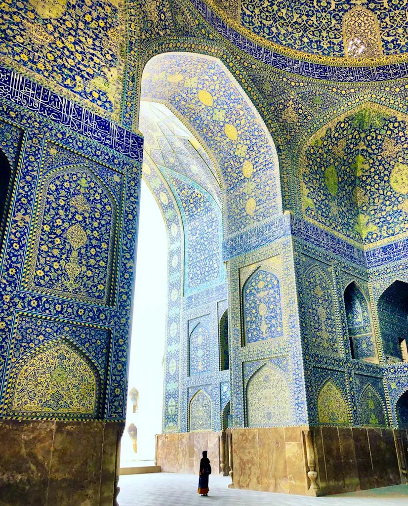 A woman is standing inside a blue and white building.