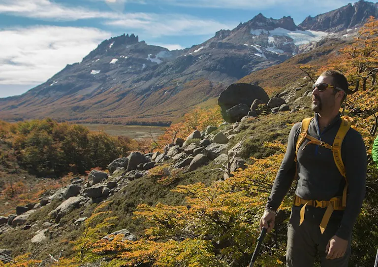 Two hikers on a hiking trip with mountains in the background.