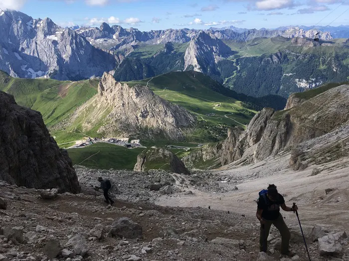 A group of hikers on a rocky trail in the mountains.