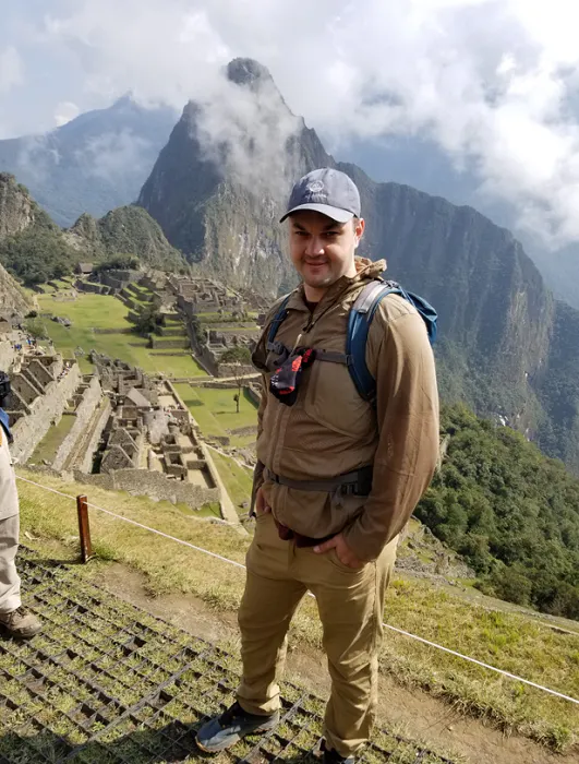 Two men standing in front of machu picchu.
