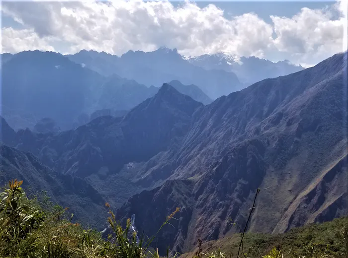 A view of the mountains from the top of a mountain.