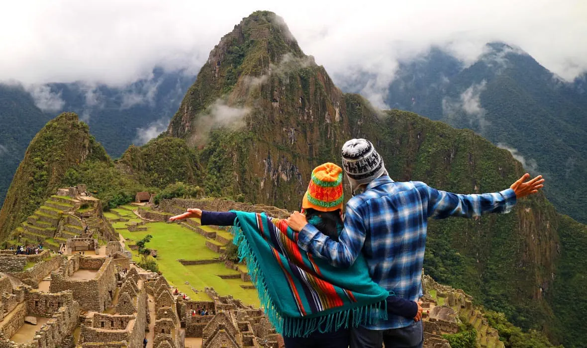 Two people standing in front of Machu Picchu during their extended Ecuador trip.