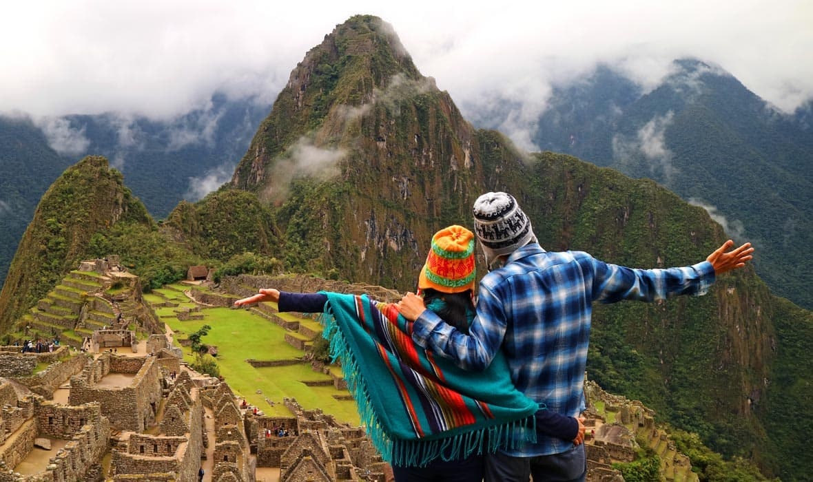 Two people standing in front of Machu Picchu during their extended Ecuador trip.