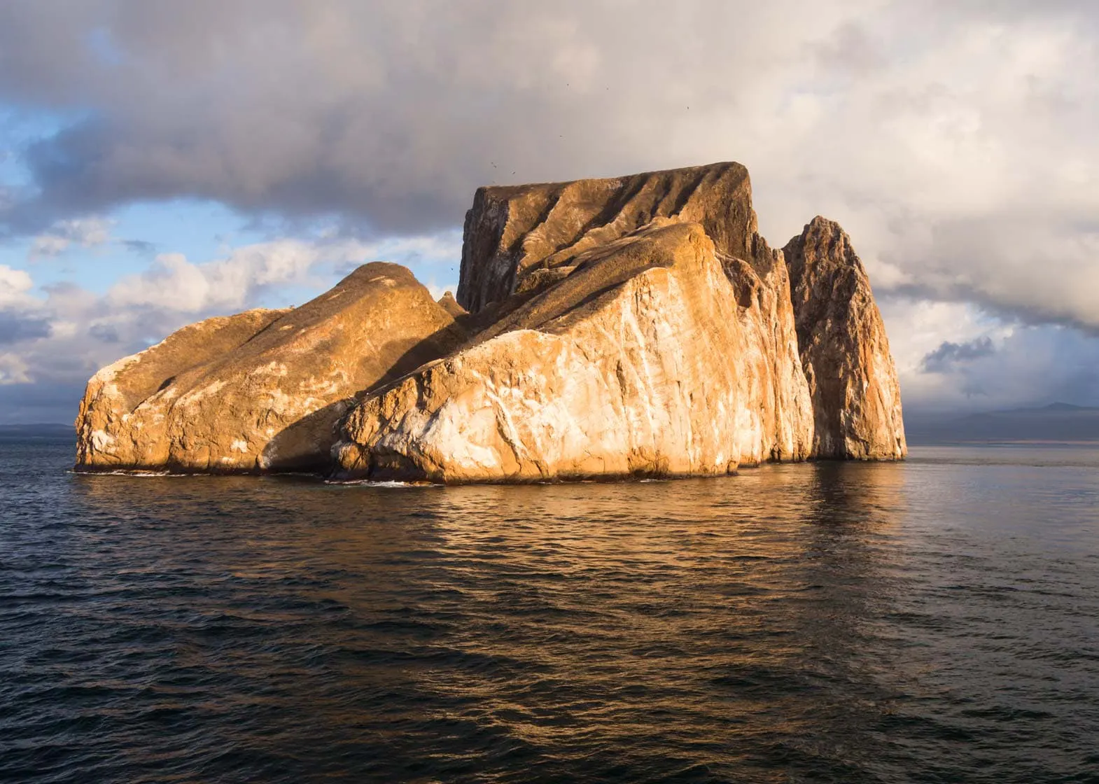 Explore a stunning rock formation in the middle of the ocean at Galapagos Islands.