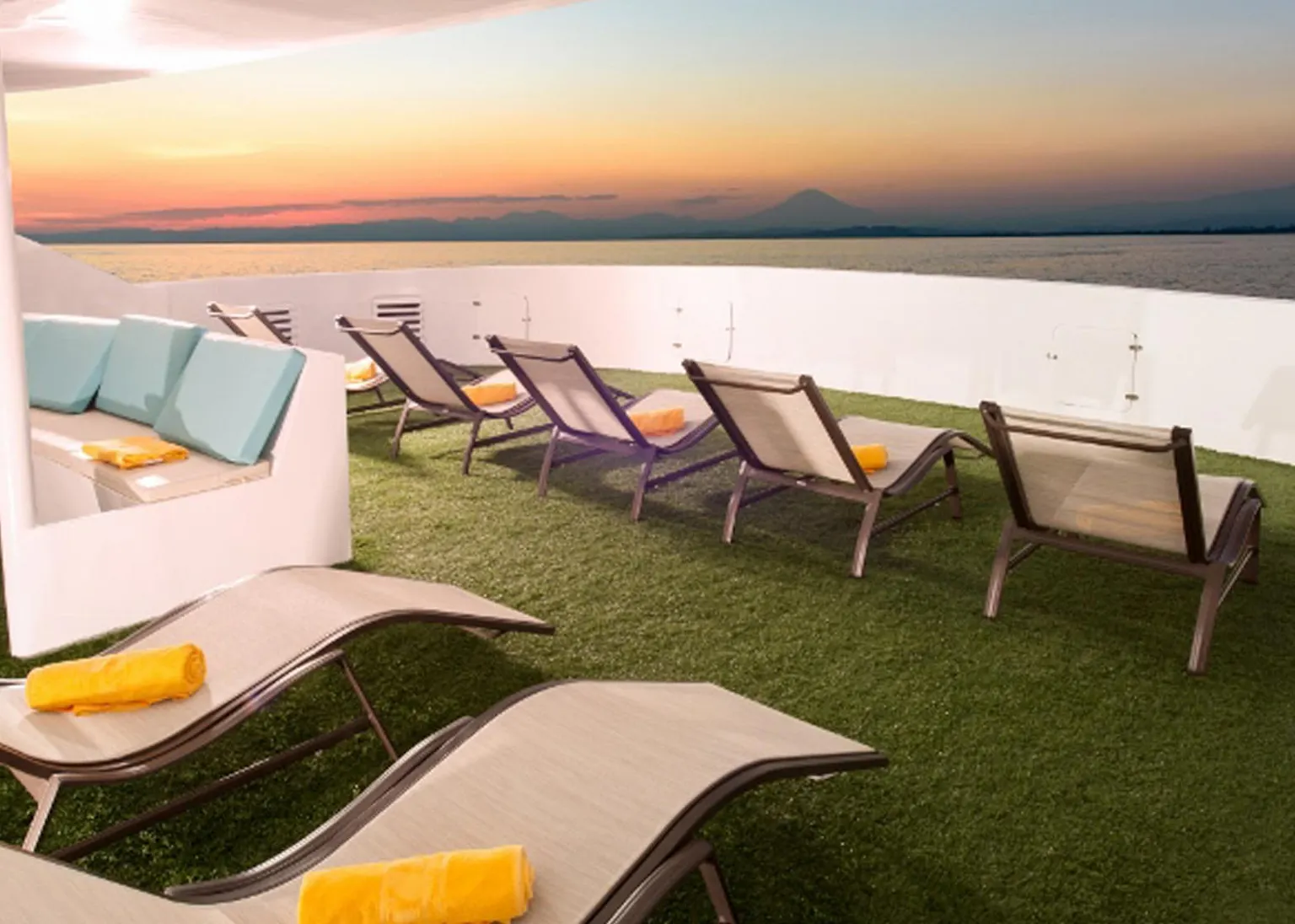The deck of a cruise ship with lounge chairs and umbrellas.