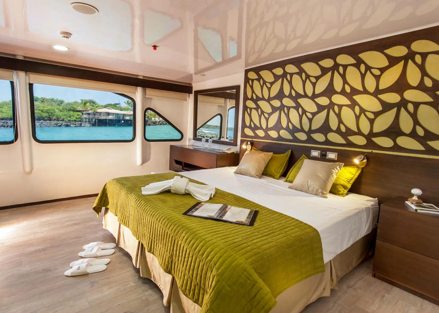 A bedroom on a boat with a view of the ocean.