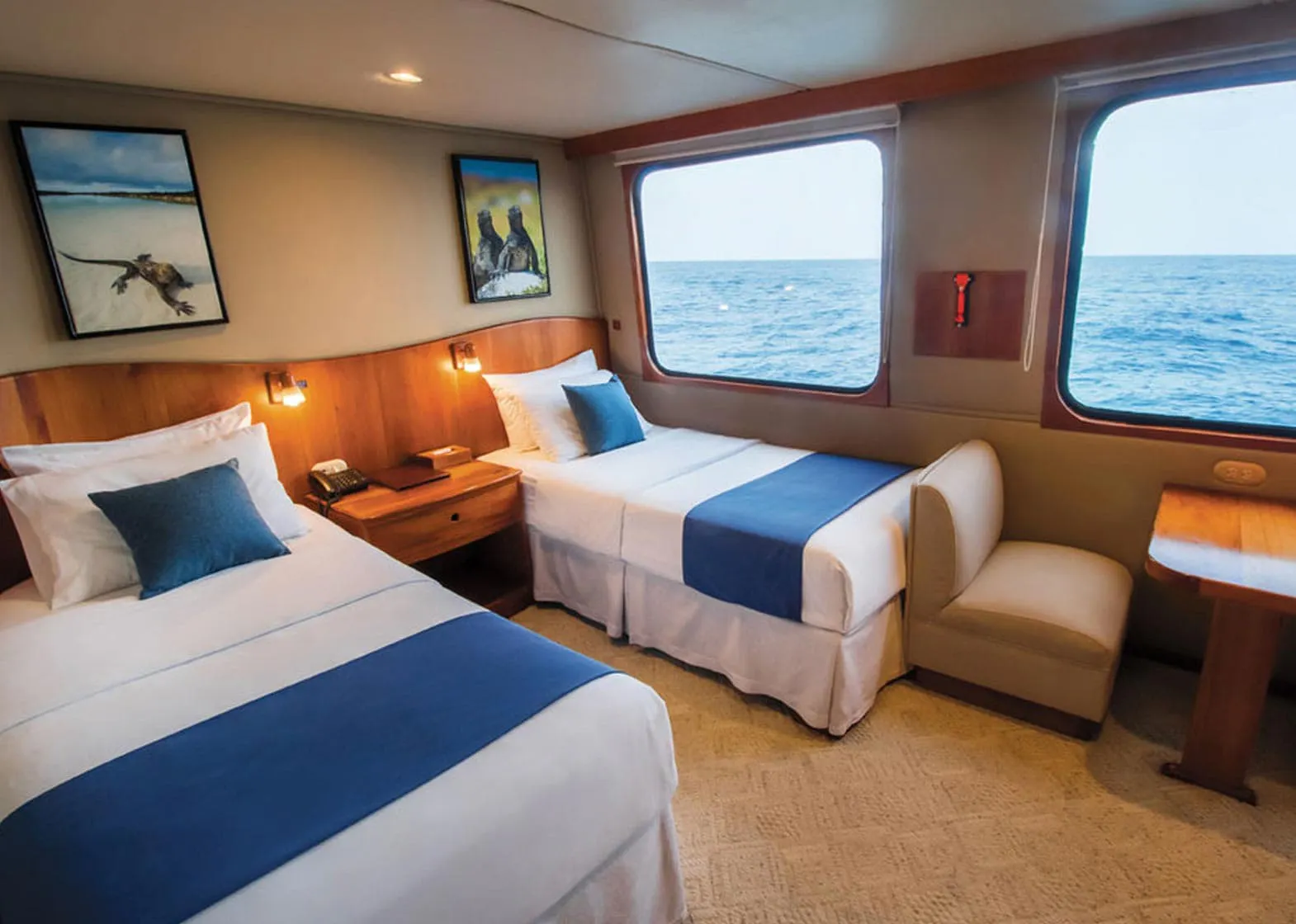 Integrity Adventure Tours offers a comfortable cabin on a boat for two people, complete with beds and a desk.