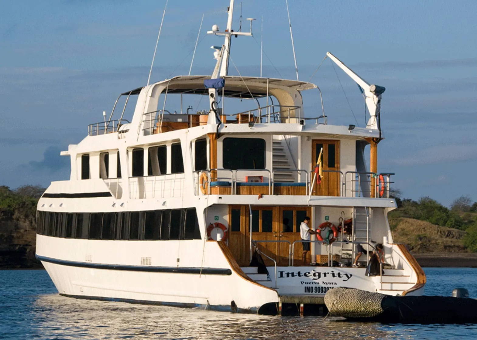 A large white boat in the water operated by Integrity Adventure Tours.