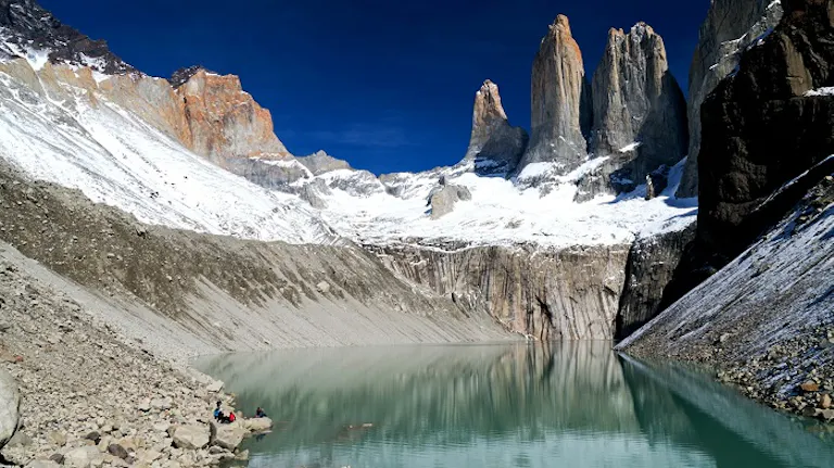 A group of people are enjoying one of the best hikes on the shore of a lake.
