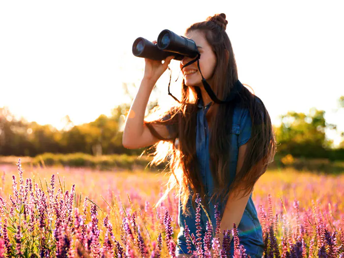 A woman practicing responsible tourism in a lavender field.