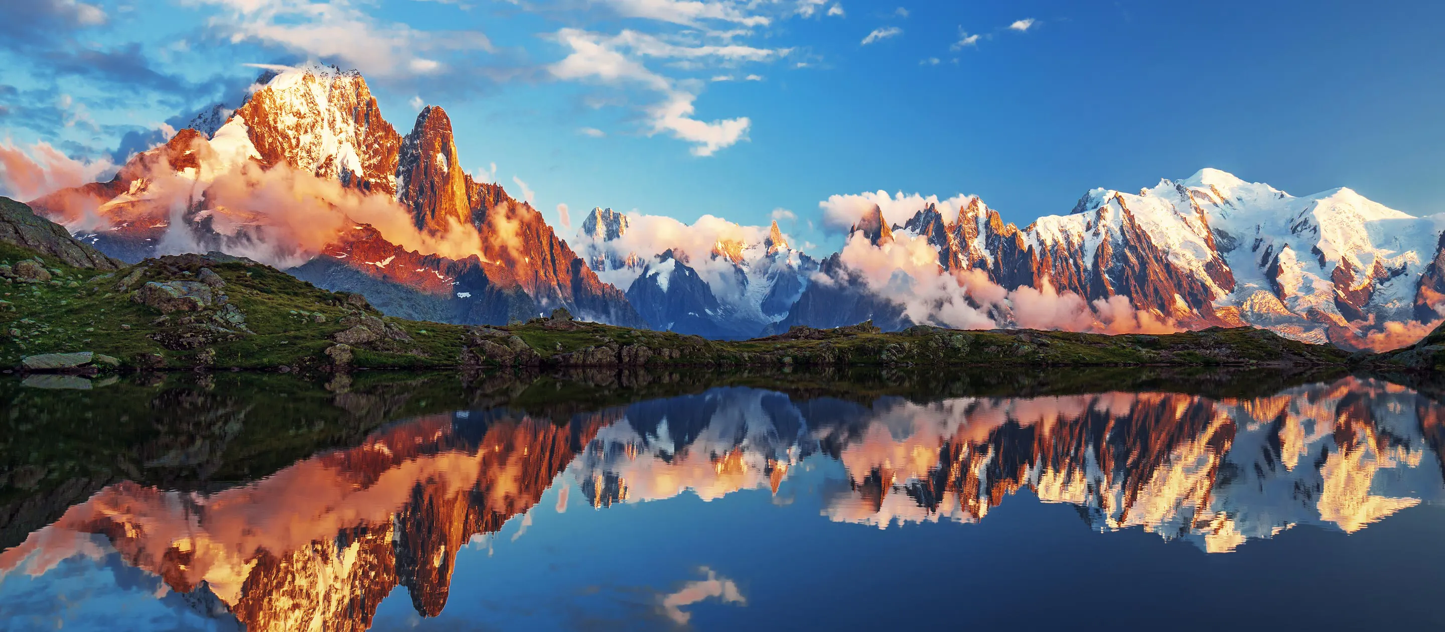 A mountain range is reflected in a lake.