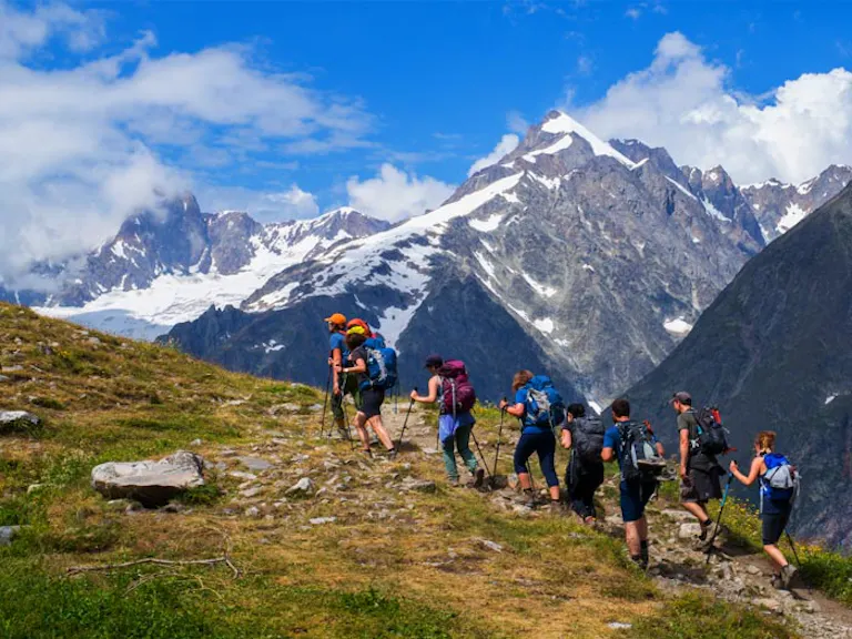 group of hikers with trekking poles on the Tour du Mont Blanc in the Alps in Europe
