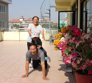 A man and woman standing on a rooftop with a child.