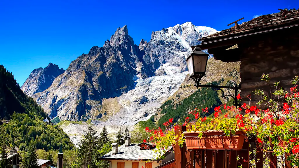 A village in the alps with a mountain in the background.