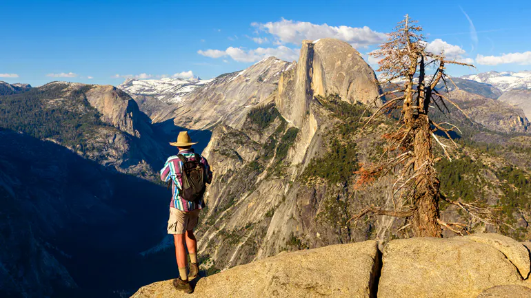 A person enjoying adventure travel on top of a mountain.