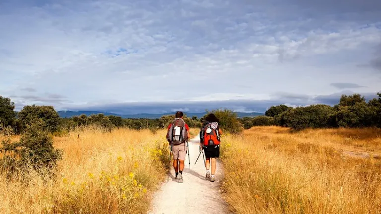 Two people enjoying one of the best hikes along a scenic trail in a sprawling field.