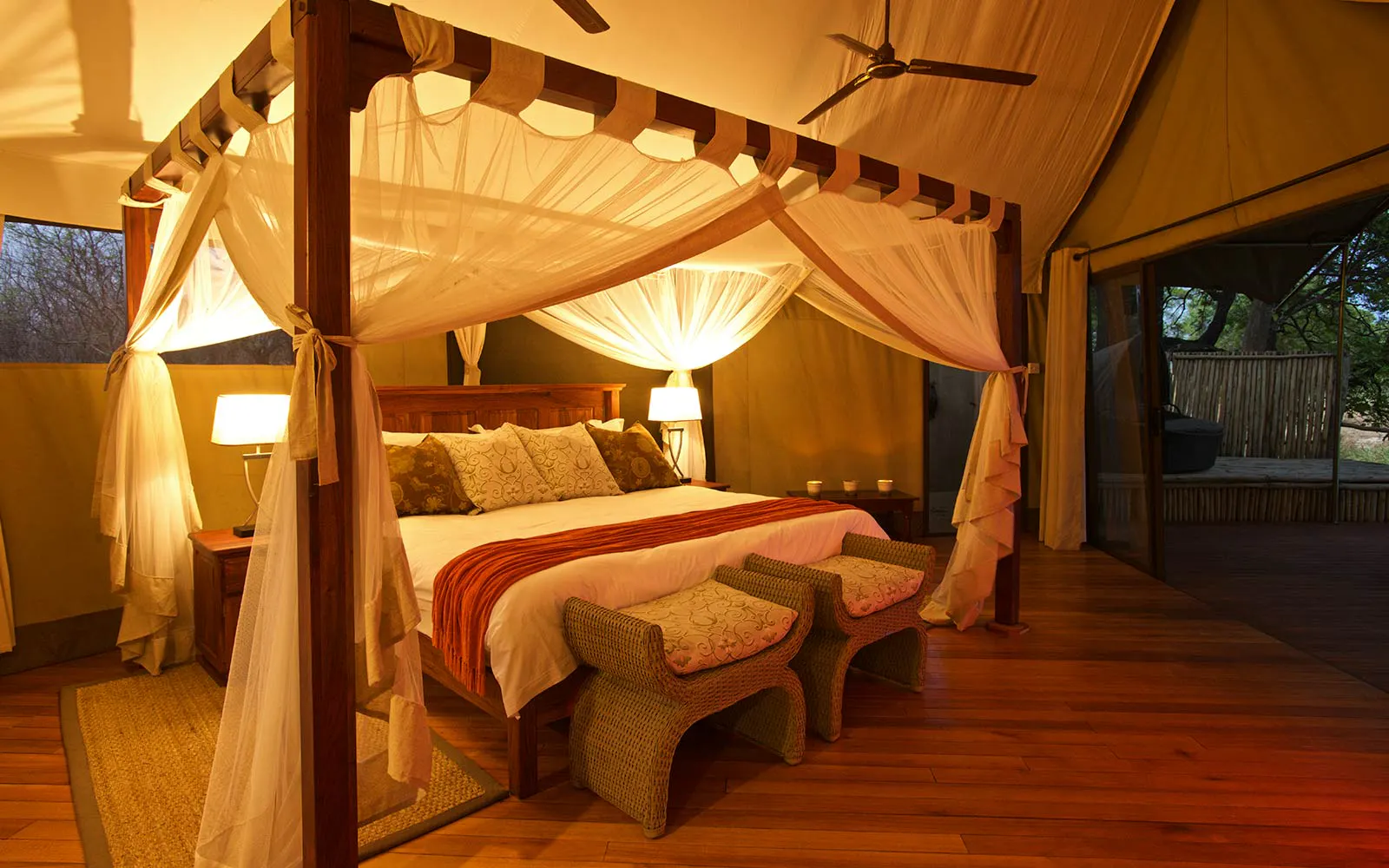 A bed in a tent with a canopy.