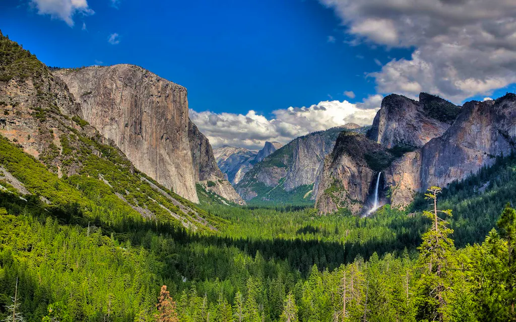 Yosemite Valley with blue sky, clouds and waterfall