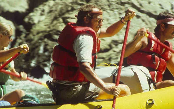 About us, a group of people are enjoying the thrill of rafting down a river.