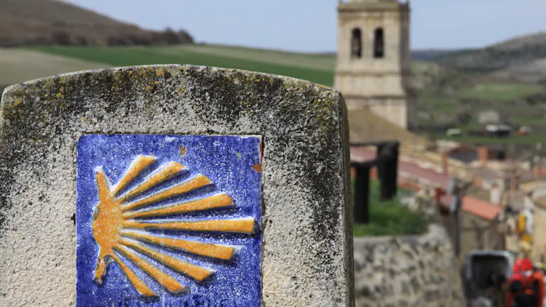 A blue and yellow sign with a sun on it.