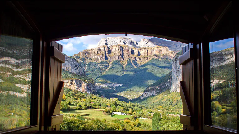 A view of a mountain from a train window.