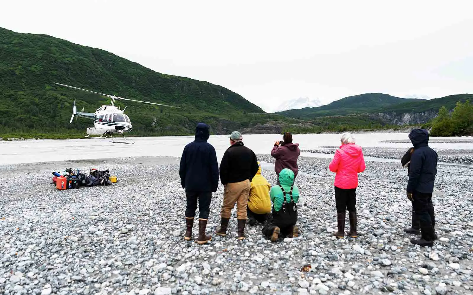 A group of people looking at a helicopter.
