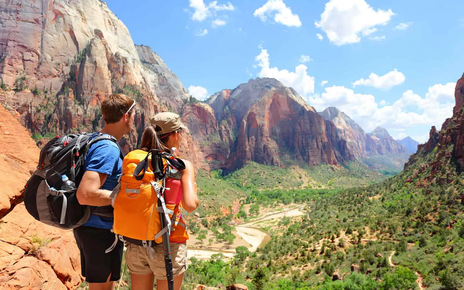 Two people hiking in zion national park.