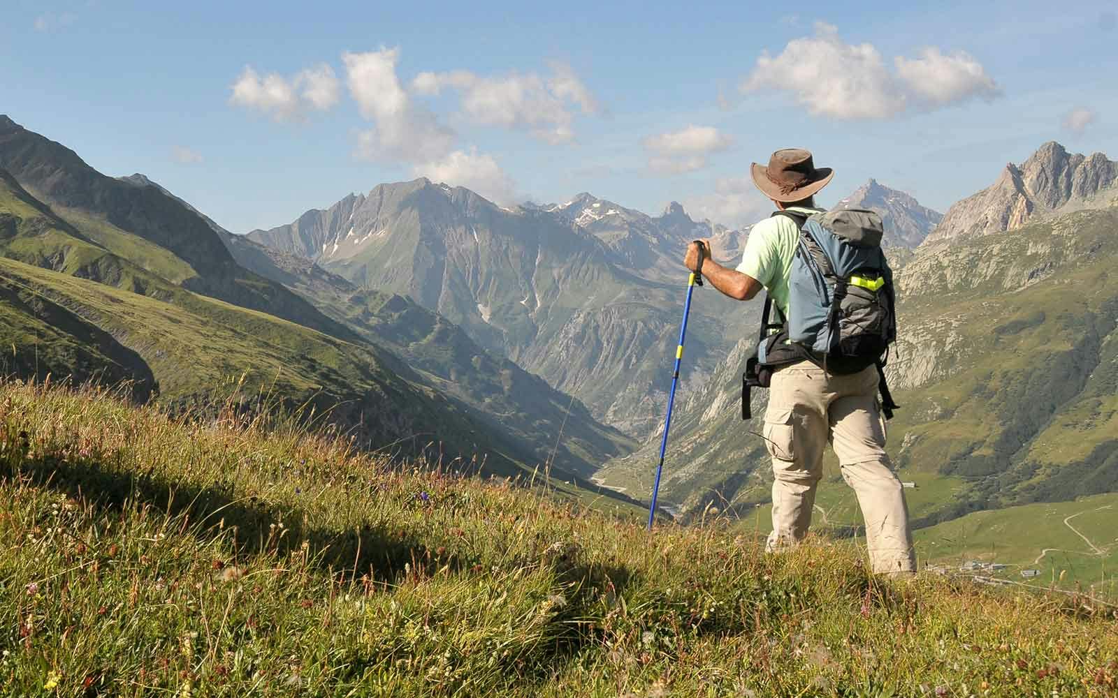 A man hiking in the mountains with a backpack.