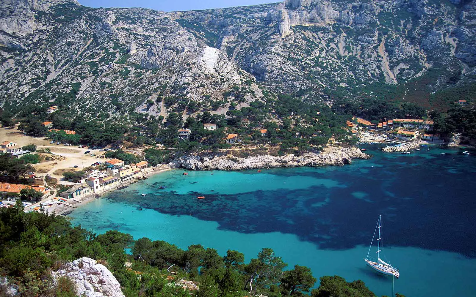 A boat is docked in the water, offering stunning views of some of the best hikes in France.
