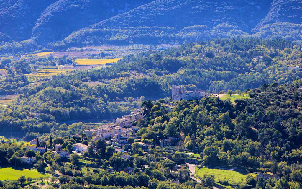An aerial view of a picturesque village nestled in the breathtaking mountains - one of the best hikes in France.