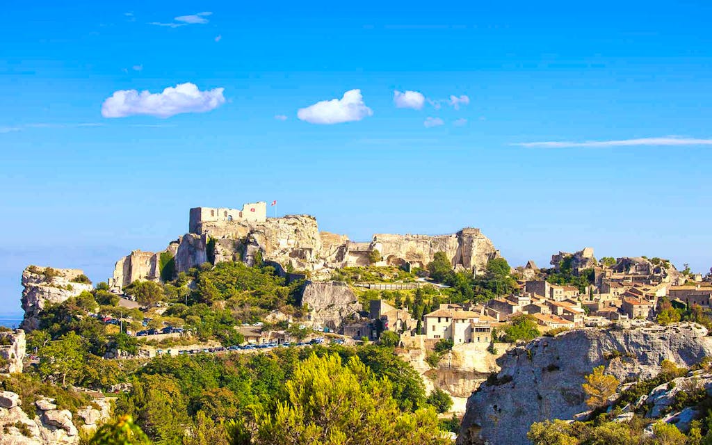 Landscape view of Marquis de Sade castle and medieval village while hiking in Provence, France.