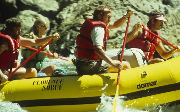 River rafting enthusiasts enjoying a thrilling adventure in a yellow raft.