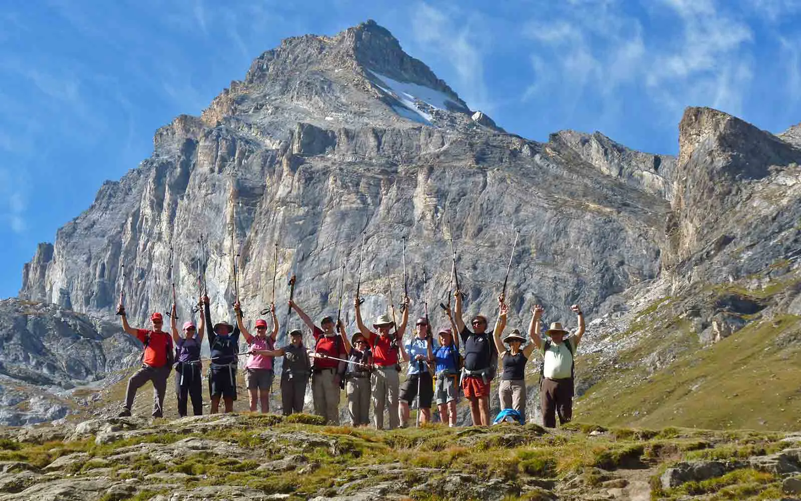A group of people standing in front of a majestic mountain during their Machu Picchu trekking tour.