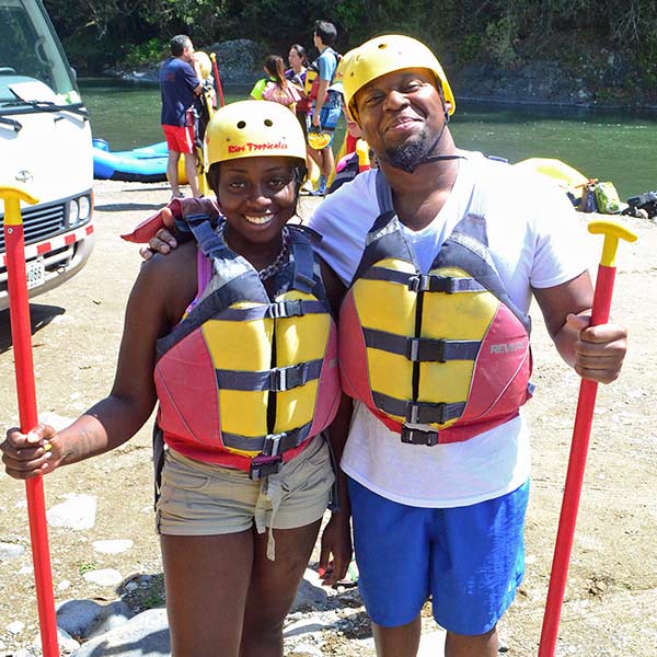 Two people in life jackets posing for a picture.