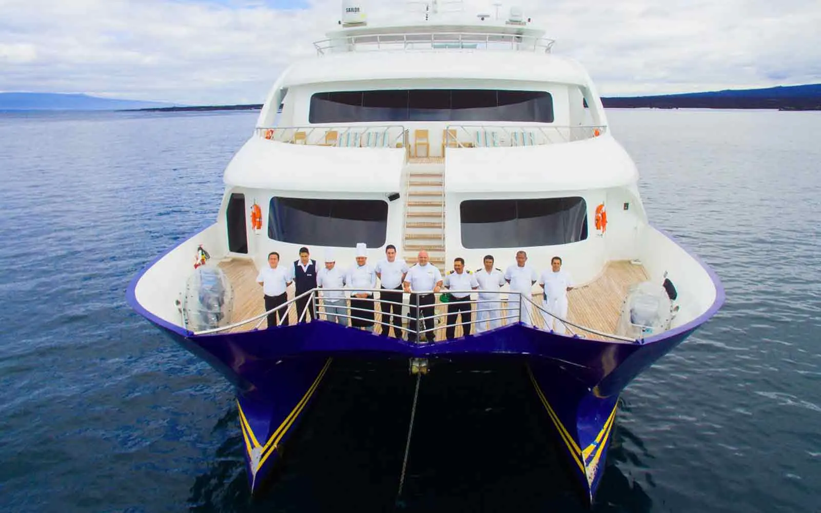 Join an exciting group of people on an Adventure Cruise as they stand at the front of a boat, ready to embark on a thrilling journey.
