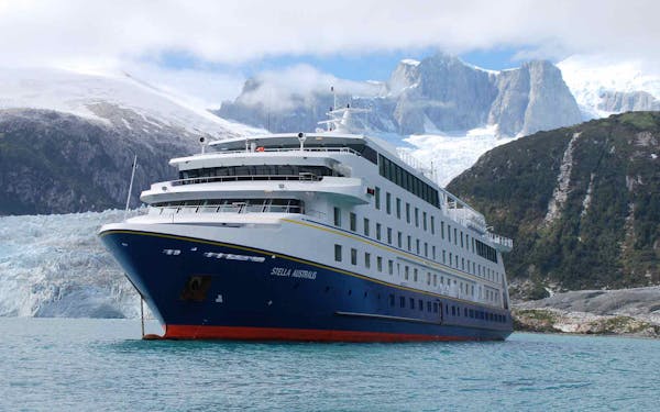 A large cruise ship embarks on an adventurous journey amidst a breathtaking glacier.