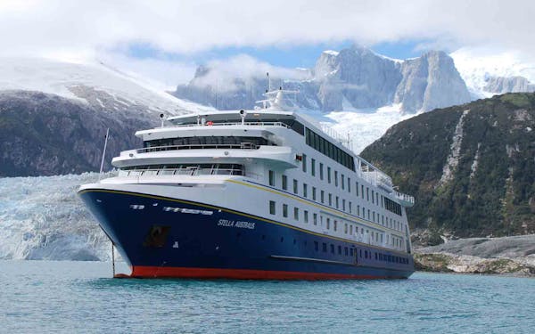 Embark on one of the best active adventures in Patagonia aboard a large cruise ship, where you can witness the breathtaking beauty of a glacier in the water.