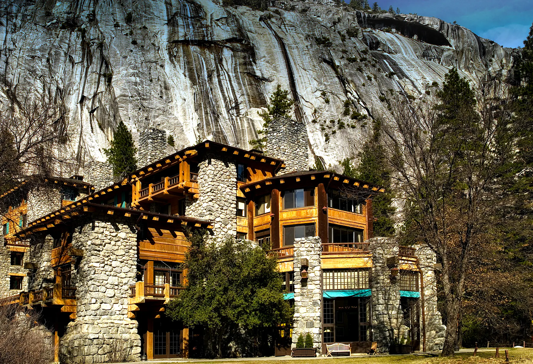 A custom-built stone building nestled in front of a majestic mountain.