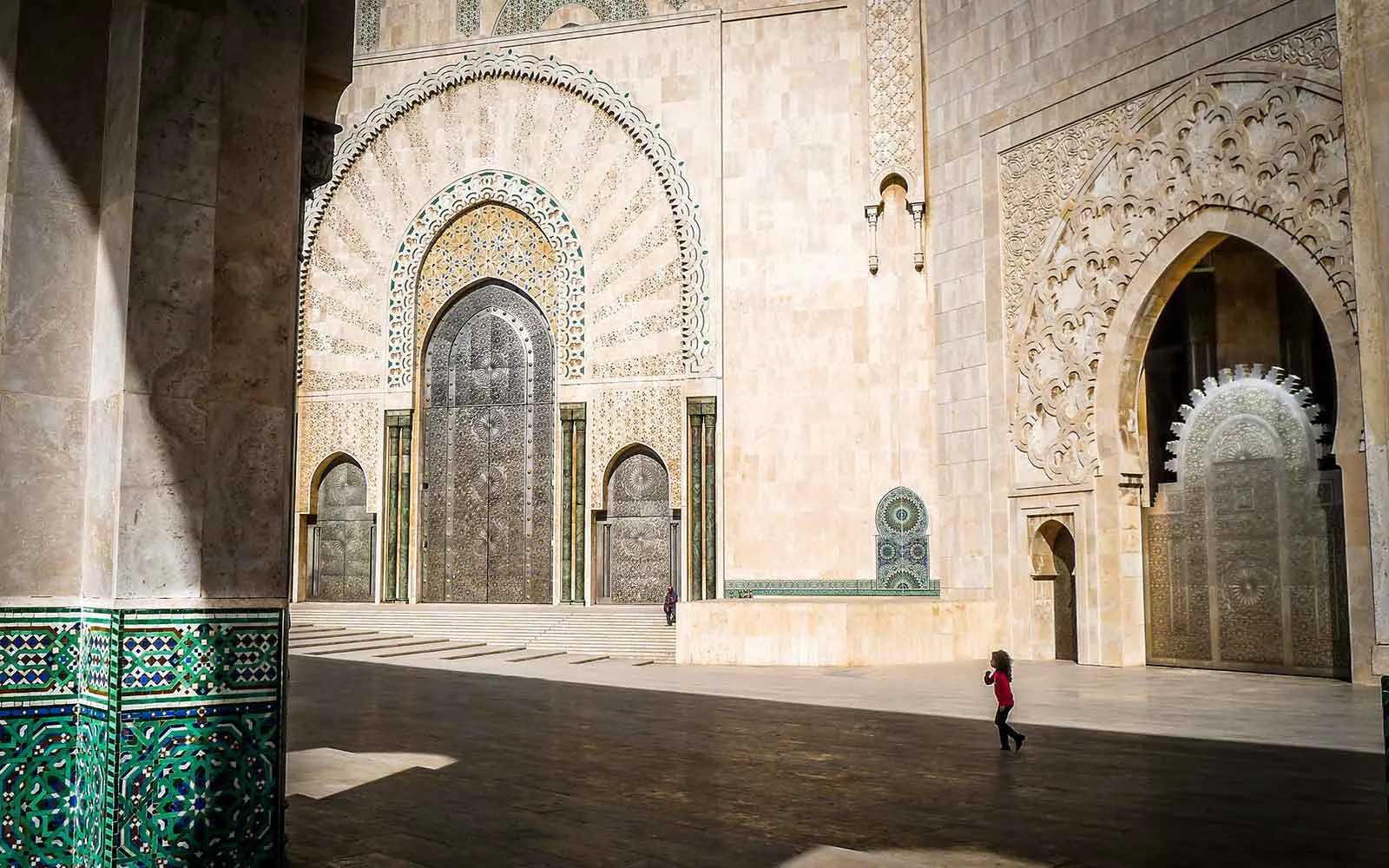 A woman explores the courtyard of a mosque in Africa.