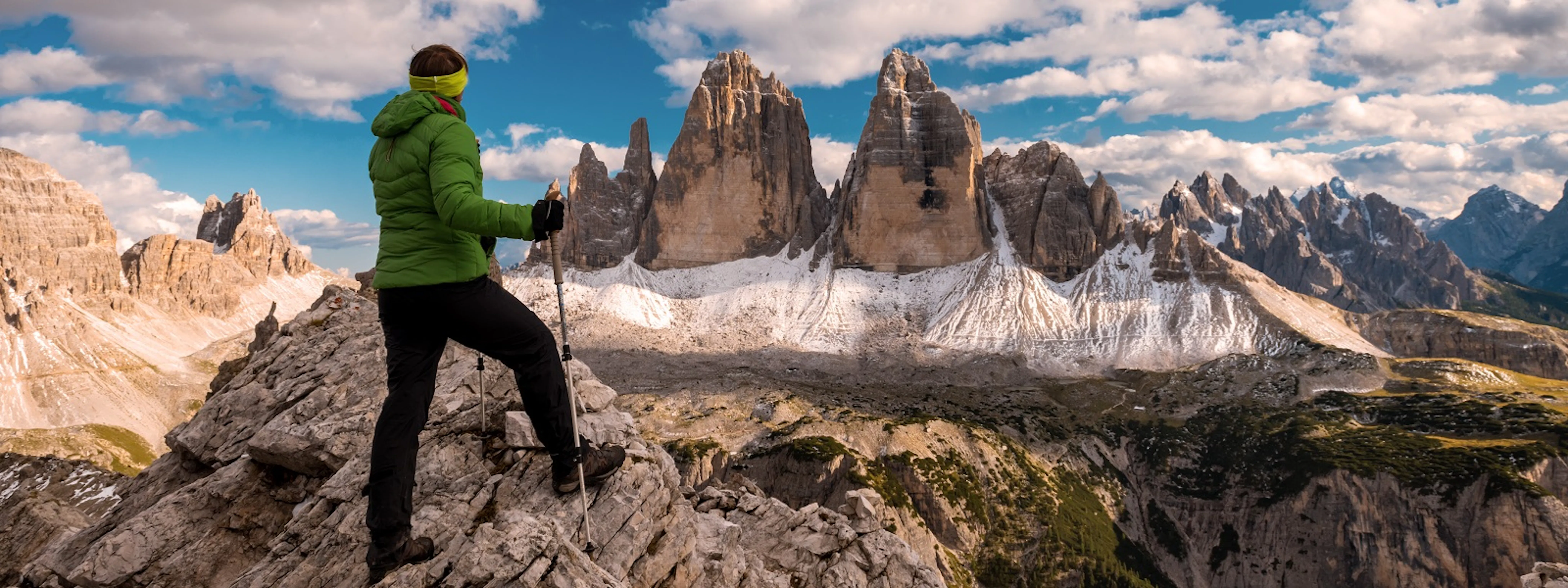 Hiker looking at Tre Cime di Lavaredo in the Dolomites, Italy