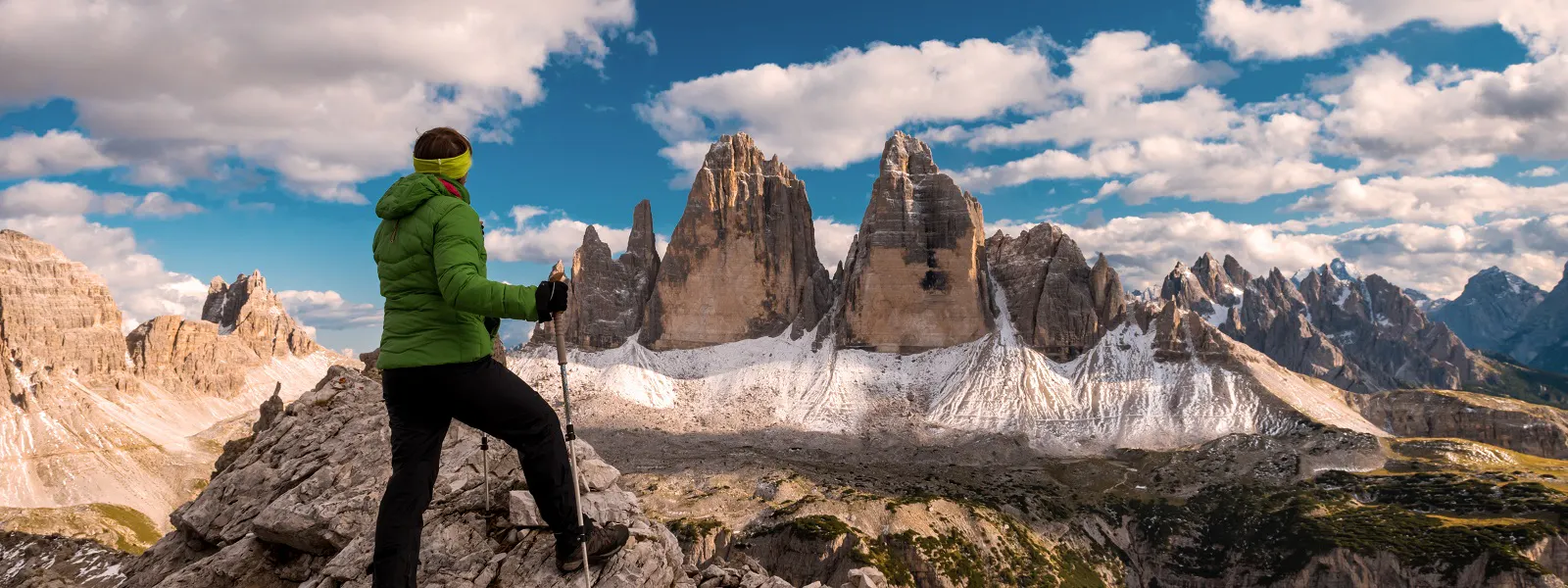 Hiker looking at Tre Cime di Lavaredo in the Dolomites, Italy