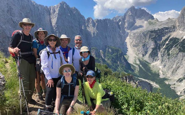 A group of hikers capturing the best alps hiking adventure in a photo.