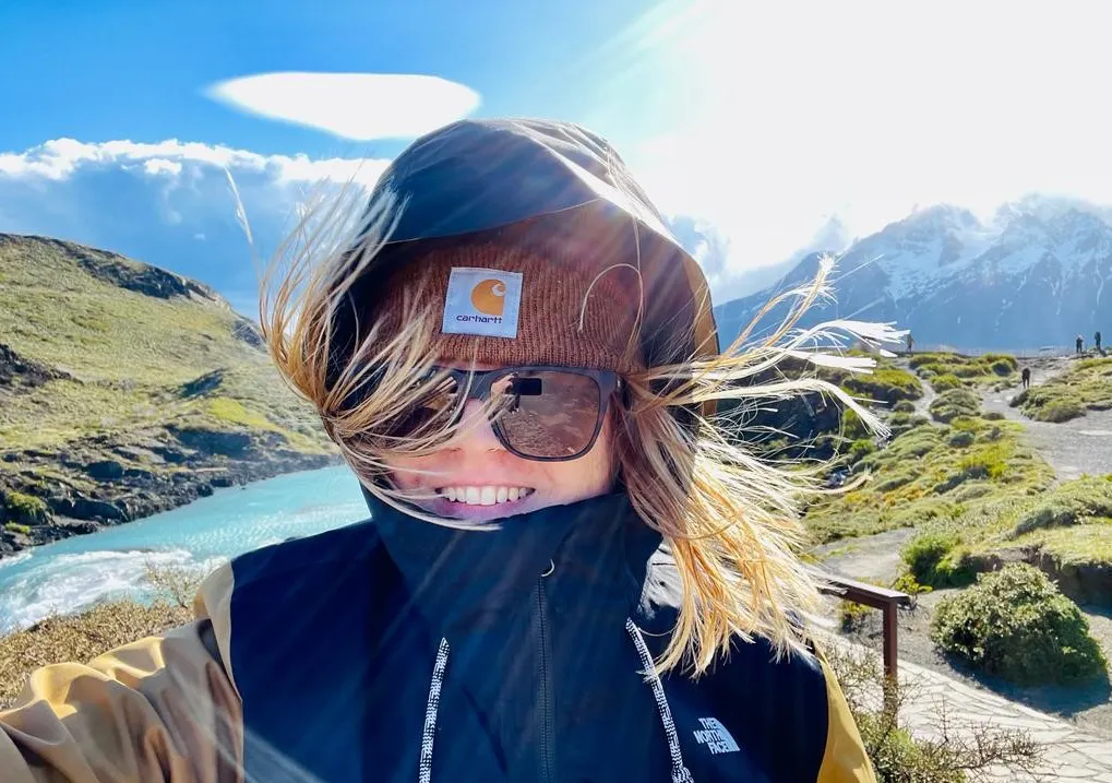 girl in a beanie is in front of Patagonia mountain views