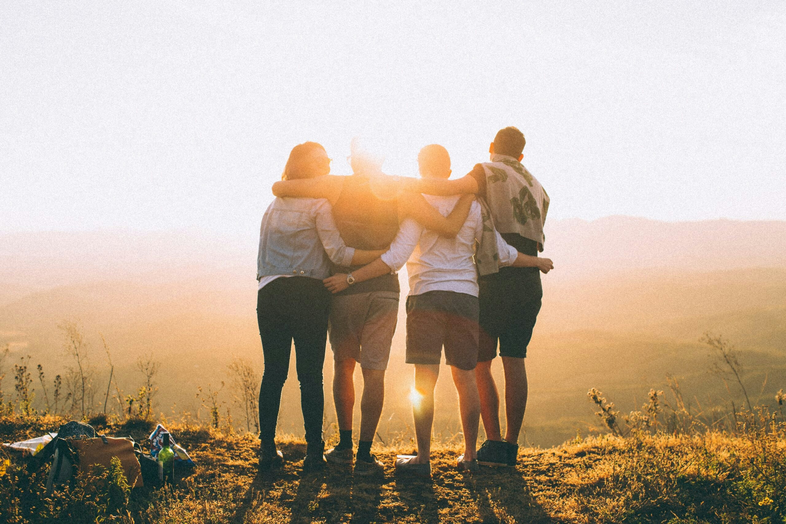 hugging friends or fellow hikers during mountain trail