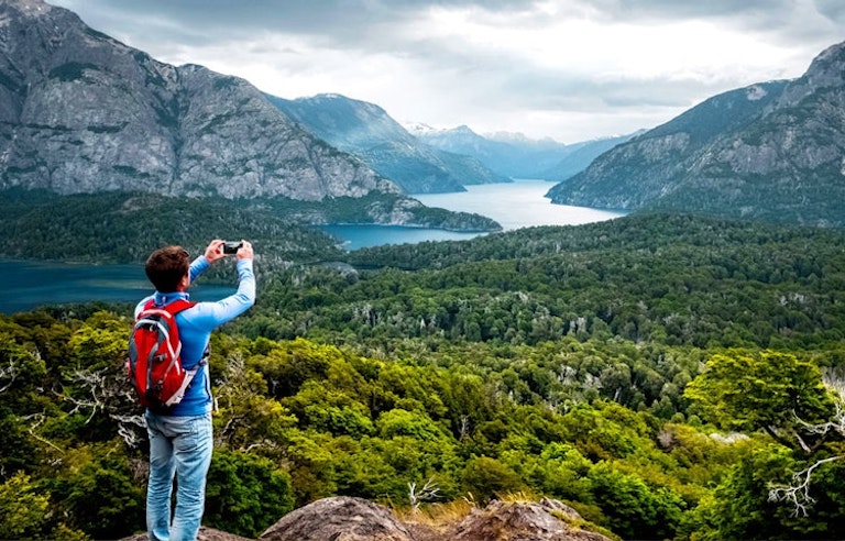 solo male hiker taking nature photography in La Araucania region on a hiking trail