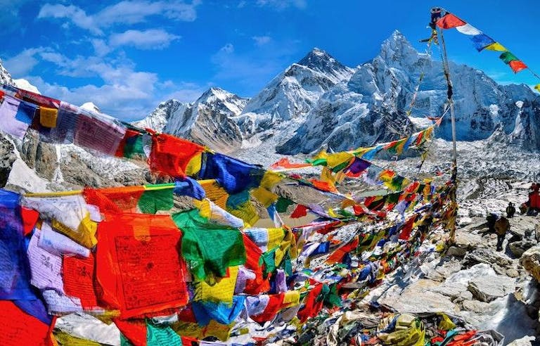 Colorful Tibetan prayer flags with snow capped Himalayan Mountains in the background