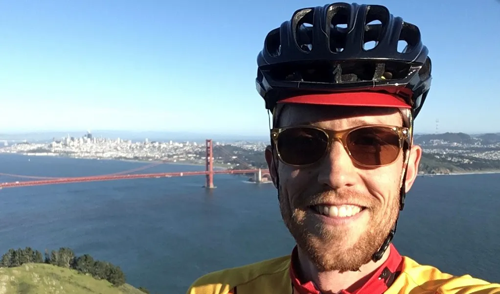male hiker with biking helmet near Golden Gate in San Francisco, California, USA in the daytime