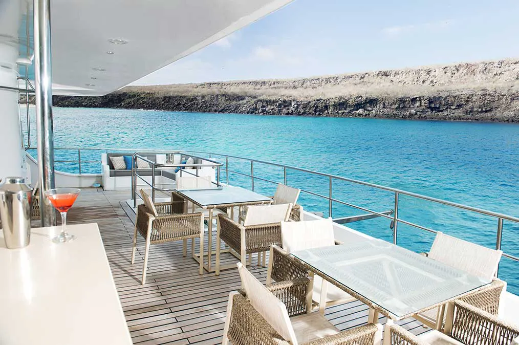 A Galapagos luxury cruise deck with a breathtaking view of the ocean.