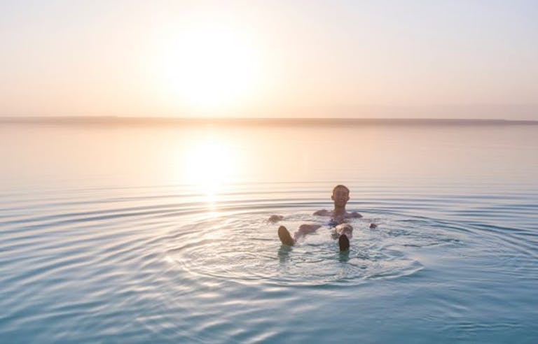 Tourist swimming leisurely on the Dead Sea in Israel