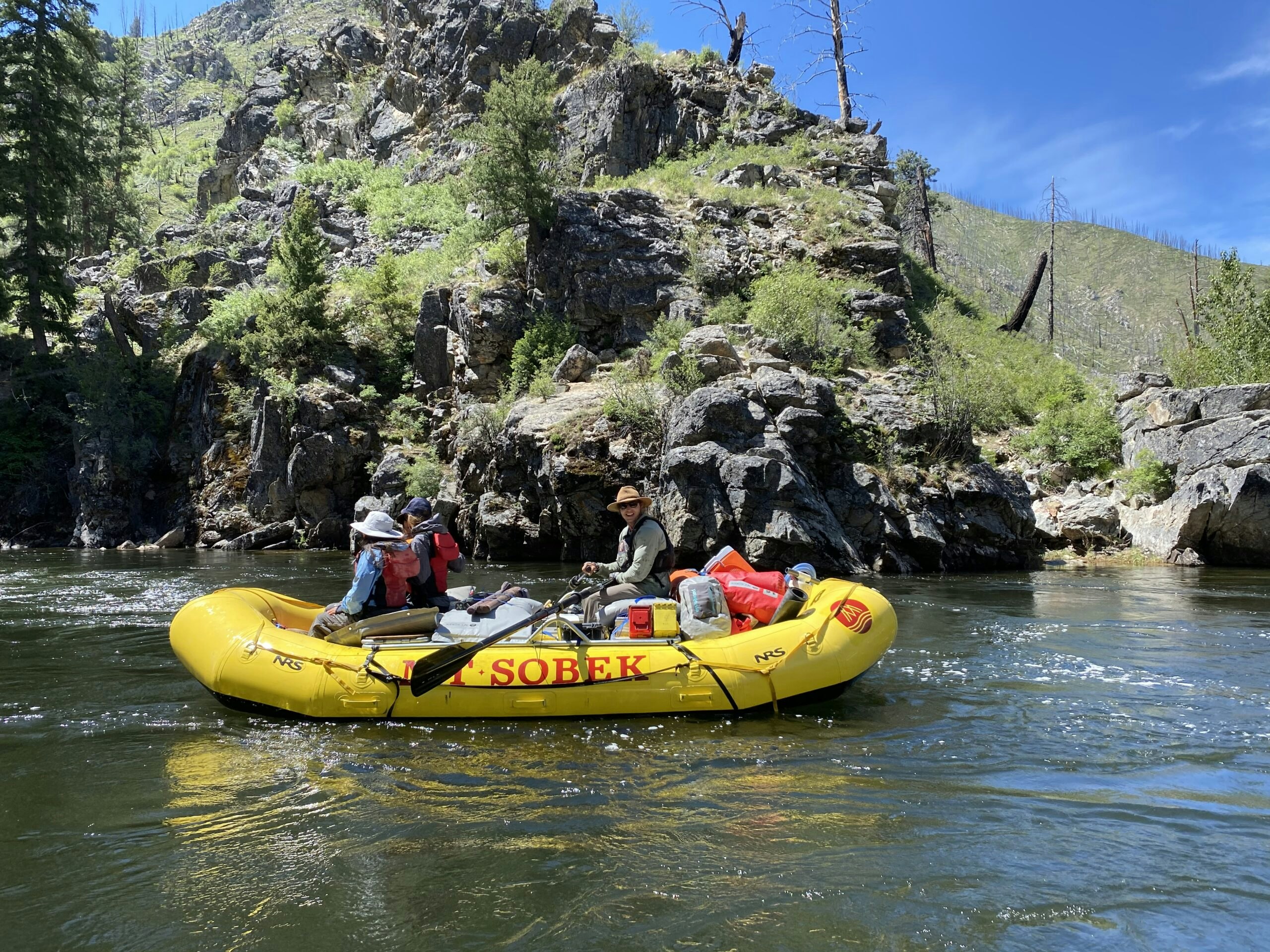 Yellow MT Sobek rafters in the middle of the Middle Fork of the Salmon River in Idaho